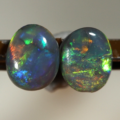 SOLID SEMI BLACK OPALS Matching pair. Bright multicolour